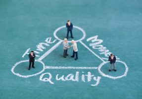 business miniature people shaking hand in balance time , quality and money diagram